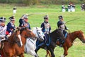 Reenactors dressed as Napoleonic war Russian soldiers ride horses Royalty Free Stock Photo