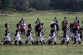 Reenactors dressed as Napoleonic war soldiers march on the battle field Royalty Free Stock Photo