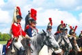 Reenactors dressed as Napoleonic war soldiers ride horses Royalty Free Stock Photo