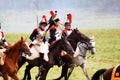 Reenactors dressed as Napoleonic war soldiers ride horses Royalty Free Stock Photo