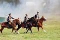 Reenactors dressed as Napoleonic war soldiers ride horses Royalty Free Stock Photo