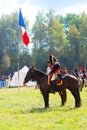 Reenactors dressed as Napoleonic war soldiers ride horses Royalty Free Stock Photo