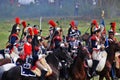 Reenactors dressed as Napoleonic war soldiers ride horses Royalty Free Stock Photo