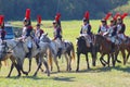 Reenactors dressed as Napoleonic war soldiers ride horses Royalty Free Stock Photo