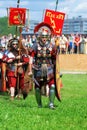 Reenactors dressed as soliders walk on green grass Royalty Free Stock Photo