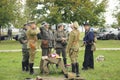 Reenactors dressed in uniforms of German officers of World War II and Russian Tsar army officers of World War I drinking vodka on