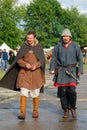 Reenactors walk on the street.