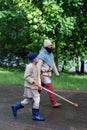 Reenactors walk on the street.