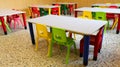 Refectory hall with colorful plastic chairs and small tables in