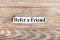 REFER A FRIEND text on paper. Word REFER A FRIEND on torn paper. Concept Image Royalty Free Stock Photo