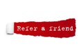 REFER A FRIEND word written under the curled piece of Red torn paper Royalty Free Stock Photo