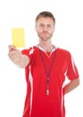 Referee blowing whistle while showing yellow card Royalty Free Stock Photo