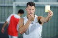 referee on football field showing yellow card Royalty Free Stock Photo