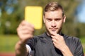 Referee on football field showing yellow card Royalty Free Stock Photo