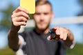 Referee on football field showing yellow card Royalty Free Stock Photo