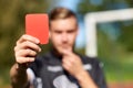 Referee hands with red card on football field Royalty Free Stock Photo