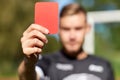 Referee hands with red card on football field Royalty Free Stock Photo