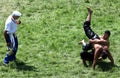 A referee looks on as wrestlers compete at the Kirkpinar Turkish Oil Wrestling Festival at Edirne in Turkey.