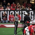 Referee Ron Snodgrass Reviews a Football Play Col