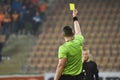 Referee shows footballer yellow card