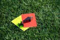 Referee soccer, football game whistle, red and yellow cards on green grass. Two penalty cards and a whistle for the referee F