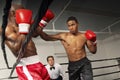 Referee Watching Boxers Fight In The Ring