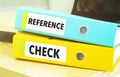 REFERENCE CHECKS on colourful folders on table