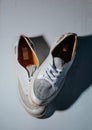 White leather shoes with brown interiors on a light gray surface. Royalty Free Stock Photo