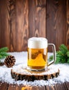 frosty mug of beer sits atop a wooden slice surrounded by snow, pine branches, and a pine cone, creating a cozy winter atmosphere. Royalty Free Stock Photo