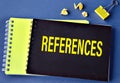 REFERENCES - word on a black notebook on a blue background Royalty Free Stock Photo