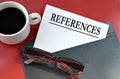 REFERENCES - word on white paper lying on a black envelope on a red background Royalty Free Stock Photo