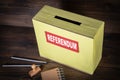 REFERENDUM. Ballot box on a wooden background