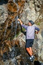 Refiling empty water bottle with a water from a stream Royalty Free Stock Photo