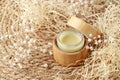 Refillable glass jar covered bamboo wood with medical salve or skin care herbal butter cream Royalty Free Stock Photo