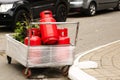 Refillable red gas cylinders are in a trailer outside.