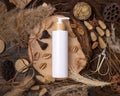 Cosmetic one pump bottle on wood near natural boho decorations top view. Label Mockup