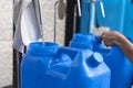 Refilling a blue 20 liter HPDE container with purified or mineral water. A purified water refilling station business Royalty Free Stock Photo