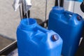 Refilling a blue 20 liter HPDE water container. A purified water refilling station business Royalty Free Stock Photo