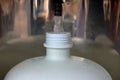 Refilling a plastic water bottle from a vending machine, shallow depth of field Royalty Free Stock Photo