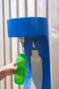 Refilling Reusable Green Water Bottle at Public Dispenser Royalty Free Stock Photo