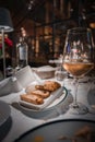 Refined dining setting with white wine, bread, and elegant decor. Royalty Free Stock Photo