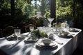 refined and elegant outdoor table setting with white linens, fine china, and shining silverware Royalty Free Stock Photo