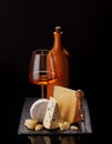 A refined selection of aged cheeses presented on a board, accompanied by a glass of wine Royalty Free Stock Photo