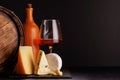 A refined selection of aged cheeses presented on a board, accompanied by a glass of wine Royalty Free Stock Photo