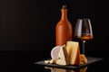 A refined selection of aged cheeses presented on a board, accompanied by a glass of wine Royalty Free Stock Photo