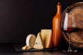 A refined selection of aged cheeses presented on a board, accompanied by a glass of wine Royalty Free Stock Photo