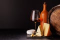 A refined selection of aged cheeses presented on a board, accompanied by a glass of wine Royalty Free Stock Photo