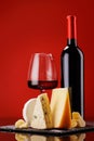 A refined selection of aged cheeses presented on a board, accompanied by a glass of wine Royalty Free Stock Photo
