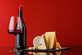 A refined selection of aged cheeses presented on a board, accompanied by a glass of wine Royalty Free Stock Photo