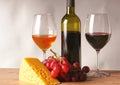 Refined still life of wine, cheese and grapes on wicker tray w Royalty Free Stock Photo